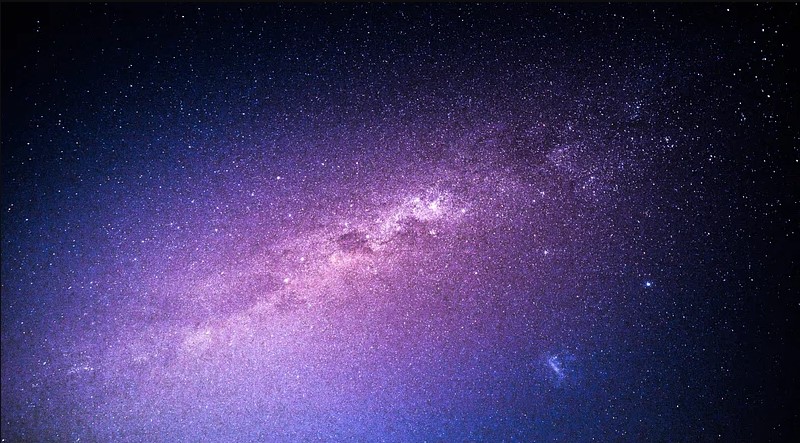 picture of deep space. There are countless stars surrounded by purples and blues that fade into a deep black in the edges of the image.